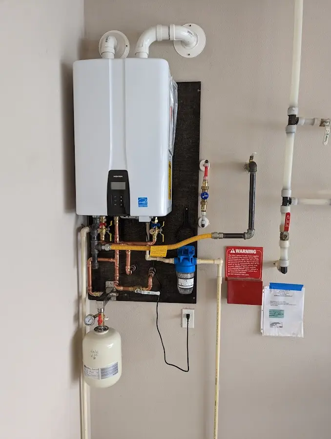 Professional plumber installing copper piping in a Bellview home